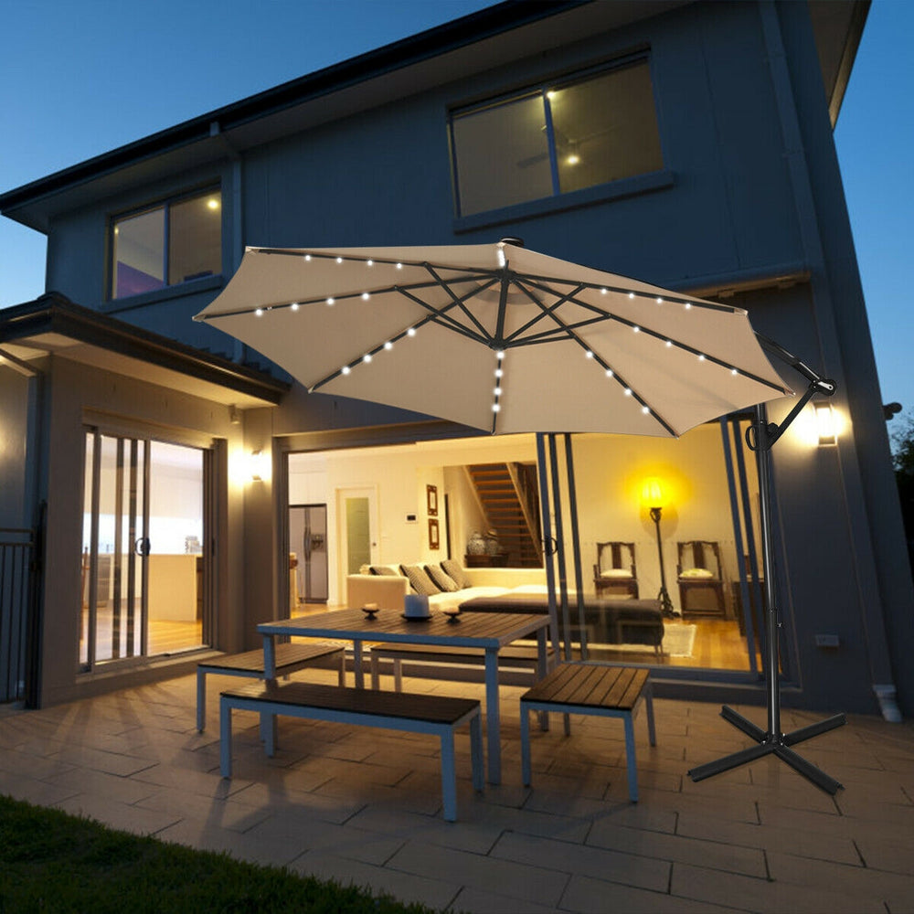 Beige 10 ft solar-powered LED patio offset umbrella with 32 lights, 360° rotation, and weather-resistant fabric for.
