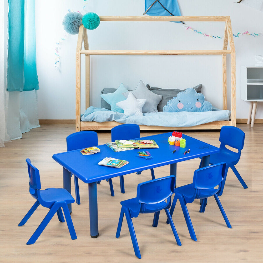 Blue kids' plastic stackable classroom chairs arranged around a table, ideal for indoor and outdoor use.