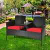 Modern patio conversation set featuring a built-in coffee table, red cushions, and durable rattan for outdoor.