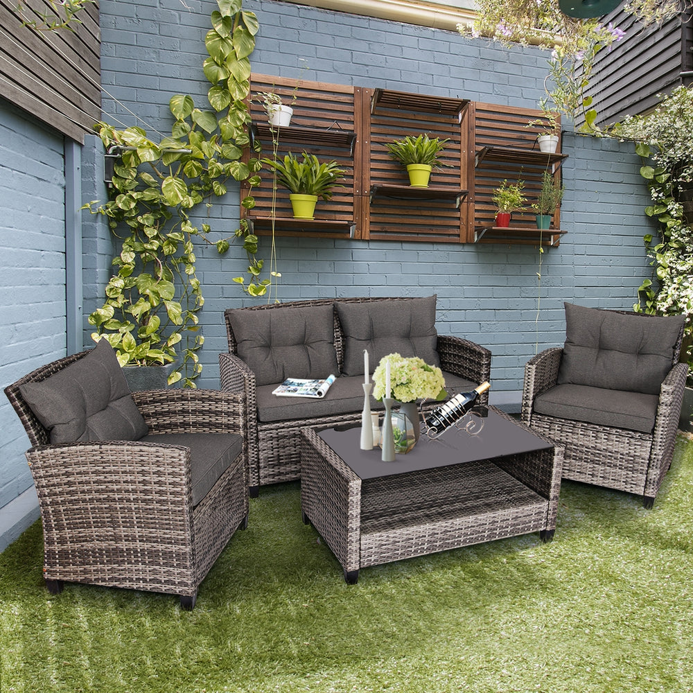 Modern 4-piece patio rattan furniture set with gray cushioned sofas and coffee table, perfect for outdoor relaxation.