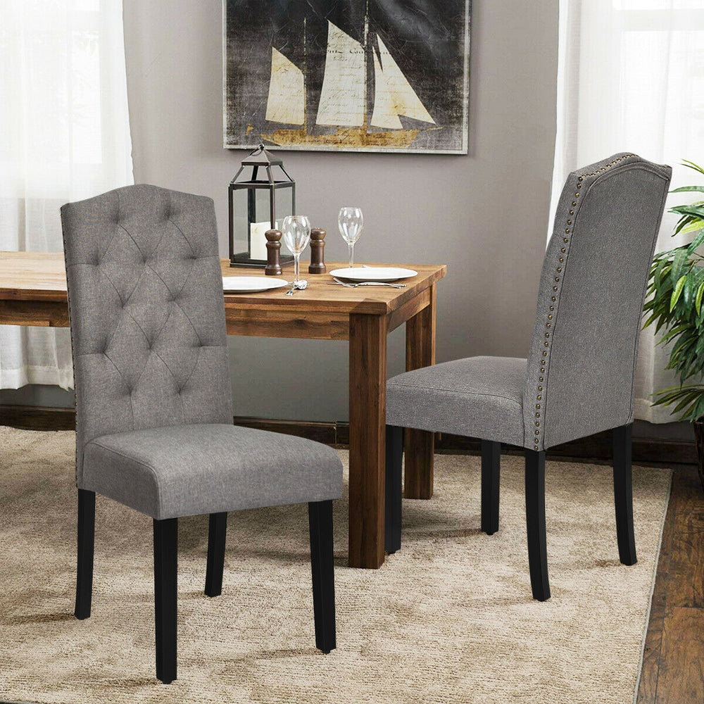 Set of 2 gray tufted upholstered dining chairs with rubberwood legs, perfect for home or café use.