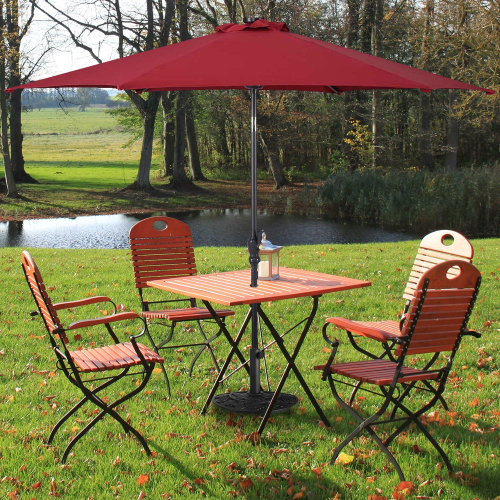 Half round patio umbrella base in antique black finish, designed for stability and durability with ornate flower.