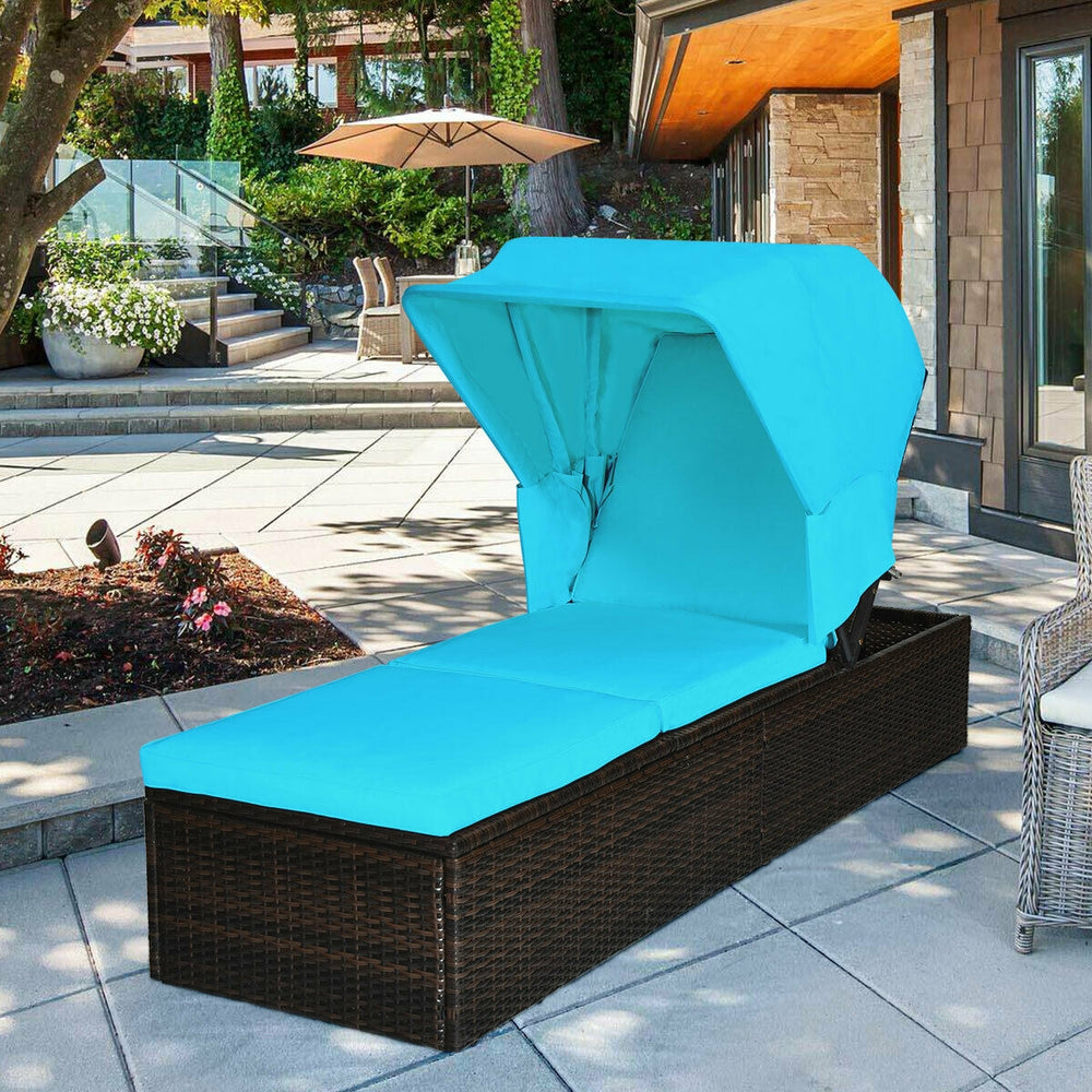 Turquoise chaise lounge chair with a folding canopy and comfortable cushion, crafted from weather-resistant PE rattan.