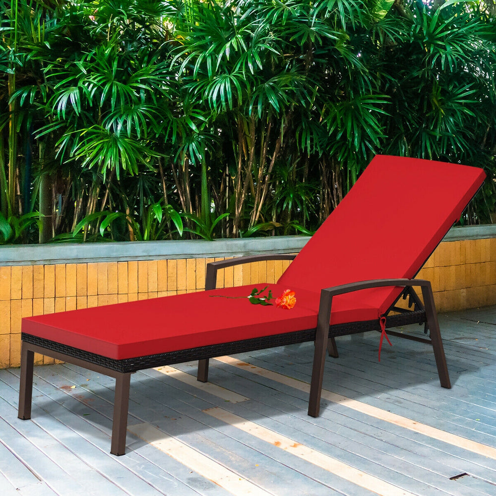 Red cushioned patio rattan lounge chaise recliner with adjustable backrest, ideal for outdoor relaxation.