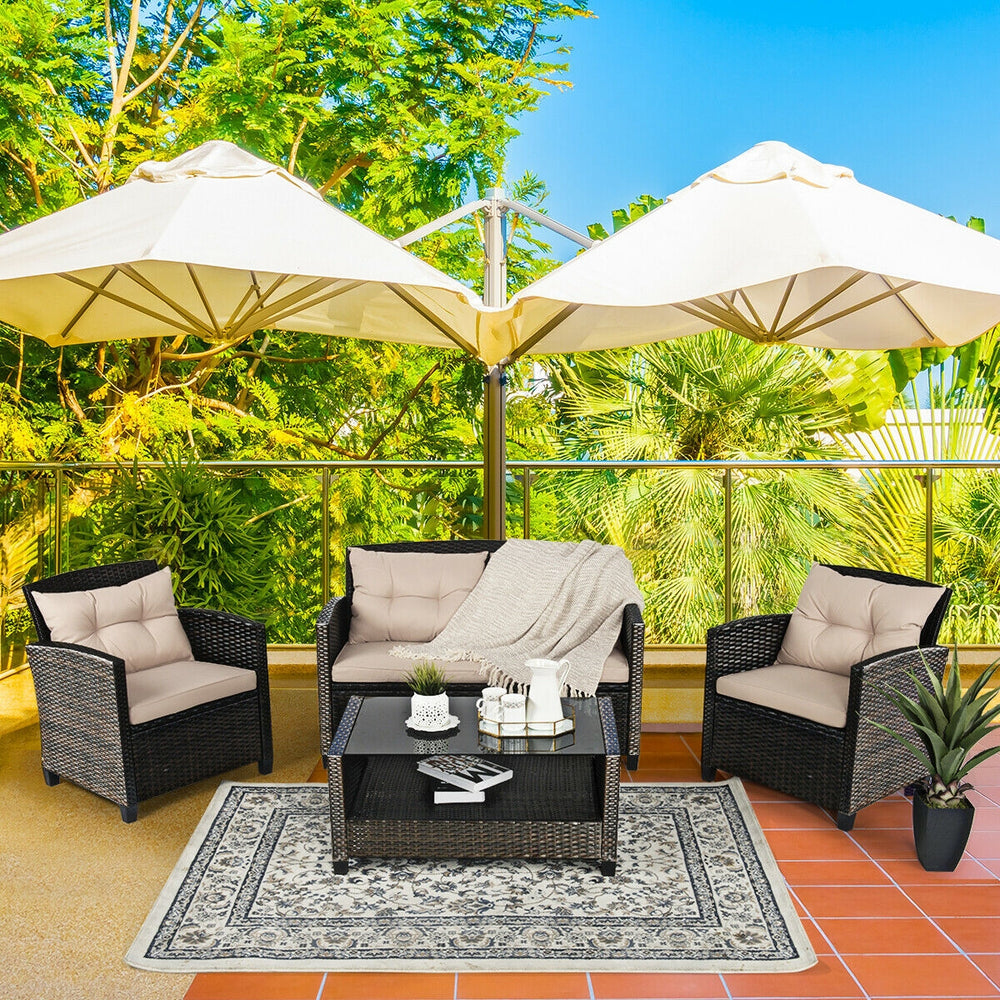Outdoor rattan furniture set featuring two single sofas, a loveseat, and a glass table, perfect for backyard relaxation.