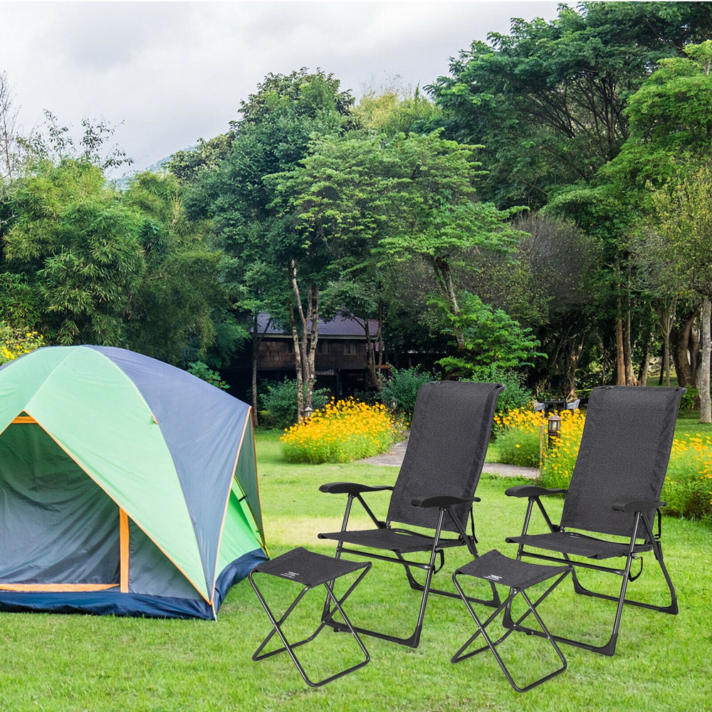 Two gray adjustable back folding dining chairs set up outside a tent in a garden, perfect for outdoor relaxation.