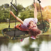 Kids enjoying the Saucer Tree Swing, featuring a durable metal frame and adjustable height for outdoor fun.