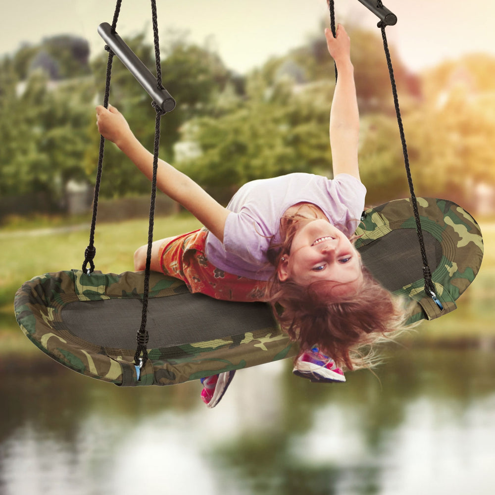 Kids enjoying the Saucer Tree Swing, featuring a durable metal frame and adjustable height for outdoor fun.