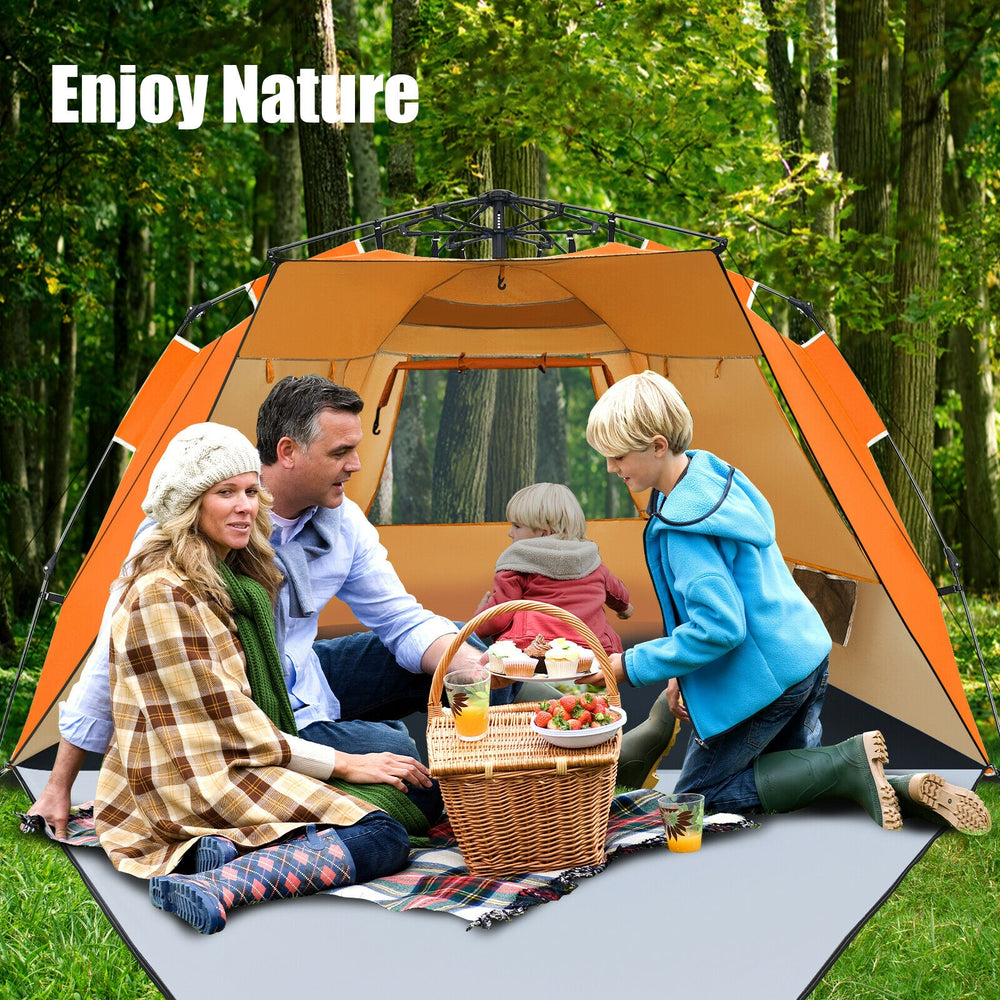 Family enjoying a picnic inside the orange 3-4 person pop-up beach tent with UPF 50+ sun protection in a forest setting.