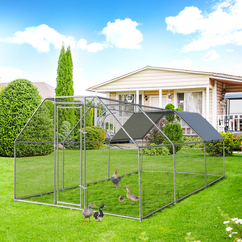 Large walk-in chicken coop with galvanized frame, PVC coated mesh, and waterproof cover for outdoor use in the backyard.