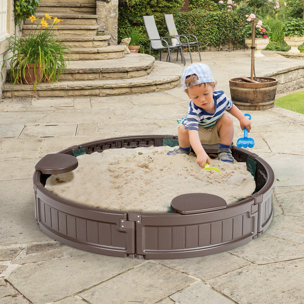 Child playing in a brown sandbox with built-in corner seats and cover, perfect for outdoor creativity and fun.