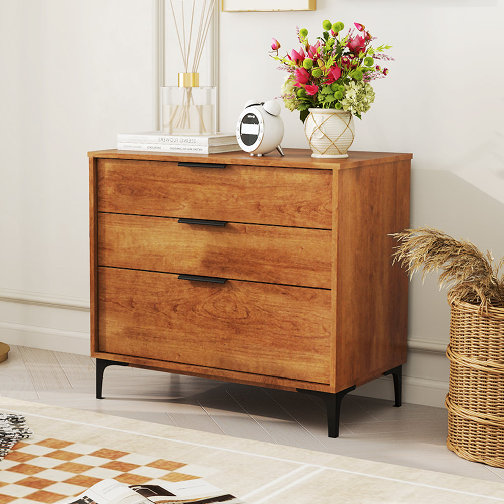 Three-drawer dresser in cherry wood finish with sleek metal handles, ideal for bedroom or living room storage.