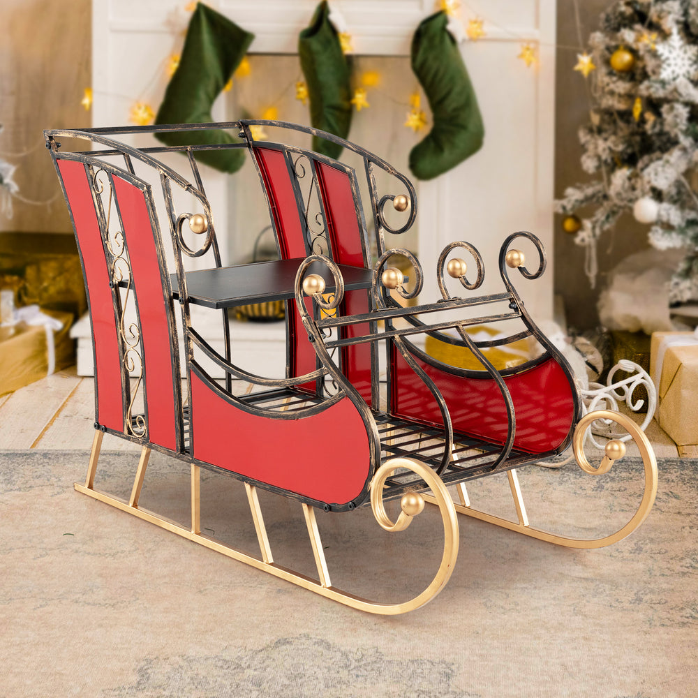 Vibrant red 3 FT Christmas metal sleigh decoration with black and gold scrollwork, featuring a 2-tier storage shelf.