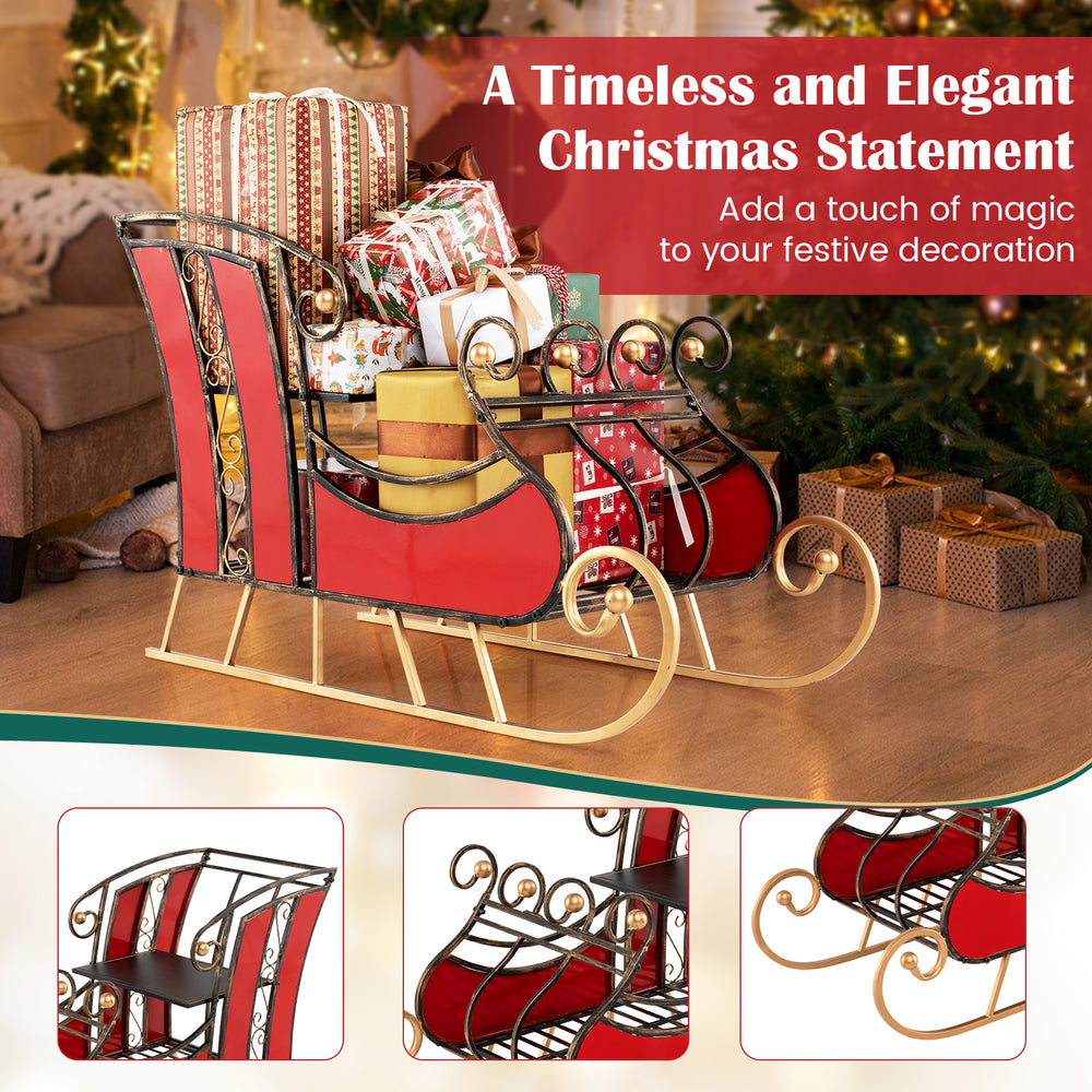 Christmas metal sleigh decoration with vibrant red body and black gold scrollwork, perfect for displaying gifts indoors.