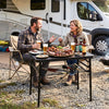 Folding camping table in black with large storage net, ideal for outdoor dining and gatherings.