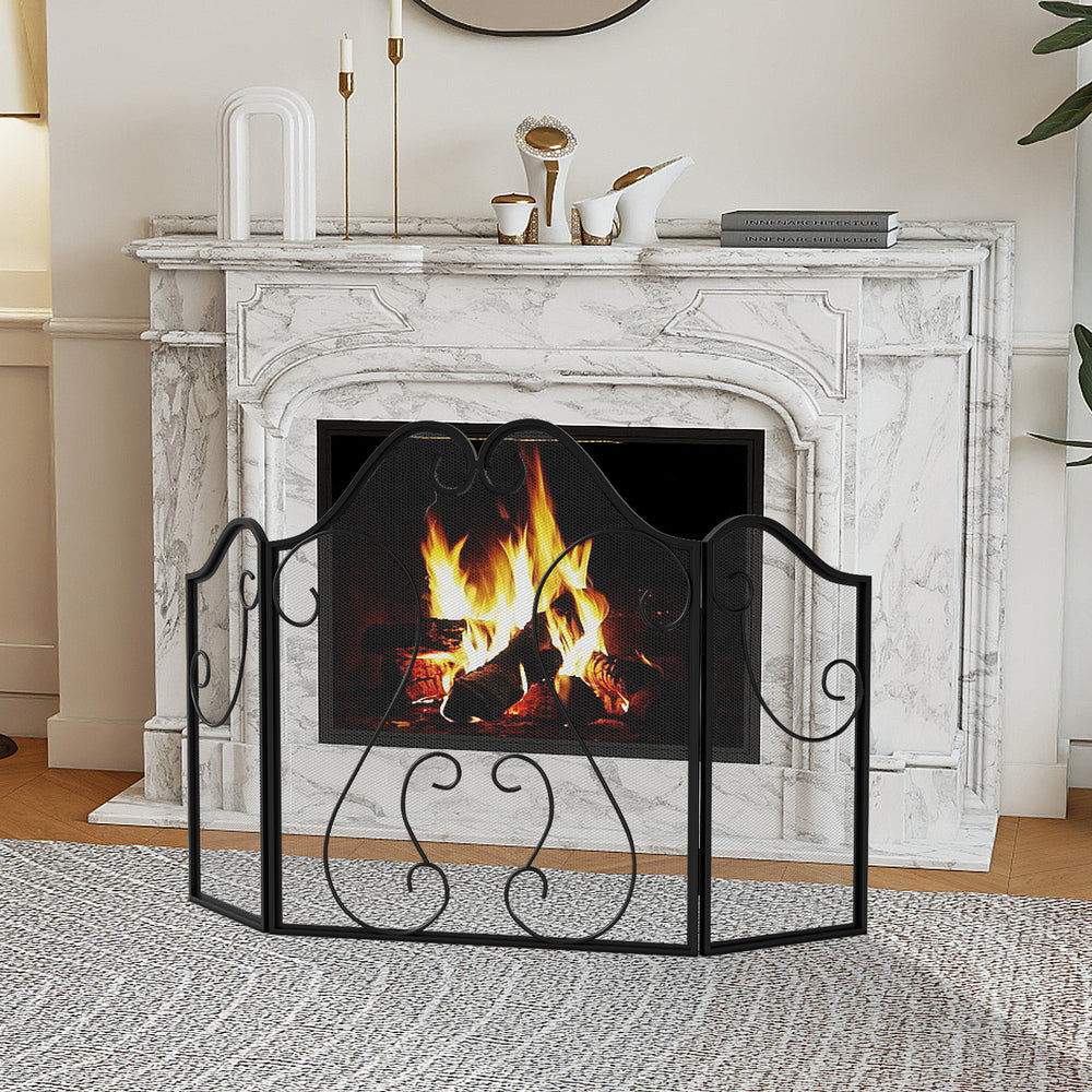 Foldable 3 panel fireplace screen in black with decorative scroll design, providing spark protection for living spaces.