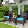 Two blue-cushioned rattan chairs and a tempered glass coffee table in a stylish outdoor setting for patio relaxation.
