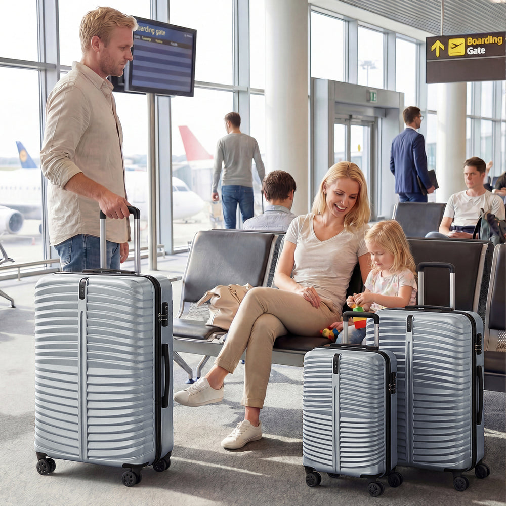 Three-piece gray hardside luggage set with 8-spinner wheels, ideal for organized travel and easy maneuverability.