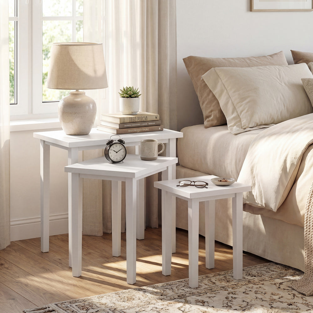 Three-piece white farmhouse side table set with sleek surfaces, perfect for living room use or as plant stands.