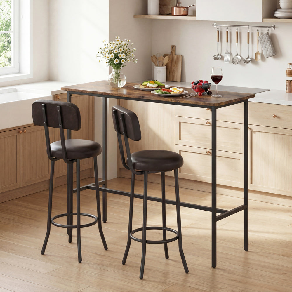 3-piece industrial bar table set featuring a rustic brown tabletop and two upholstered stools with footrests for dining.