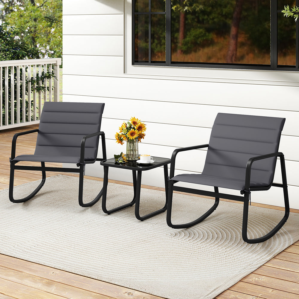 Two gray rocking chairs with a tempered glass table, perfect for outdoor patios and porches, featuring comfortable.
