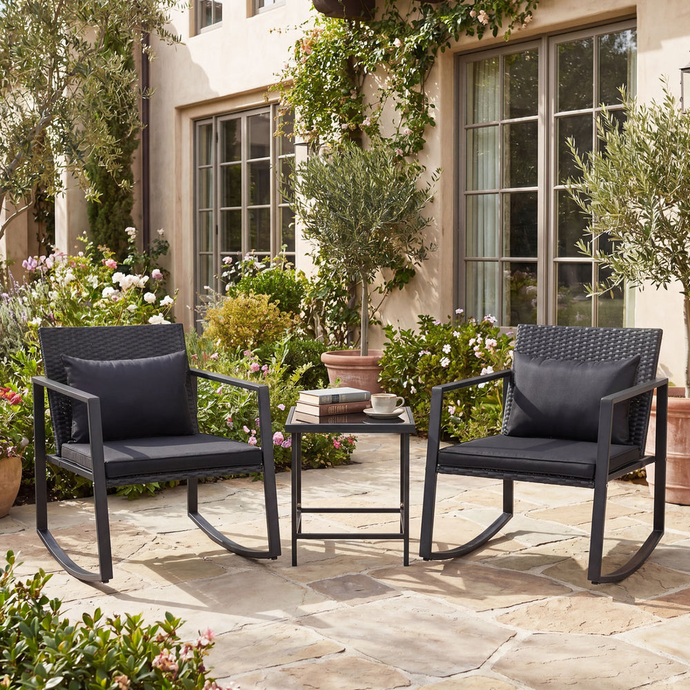 Two rocking chairs with soft cushions and a tempered glass table, perfect for outdoor patio relaxation.