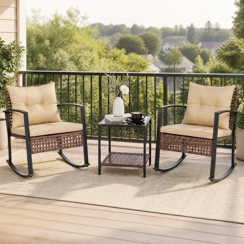 Two brown rocking chairs with thick cushions and a glass-top table create a cozy outdoor conversation space.