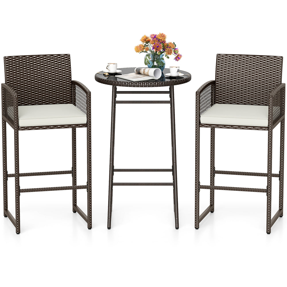 Bar height table and two ergonomic armchairs in PE wicker with soft cushions, perfect for outdoor patio relaxation.