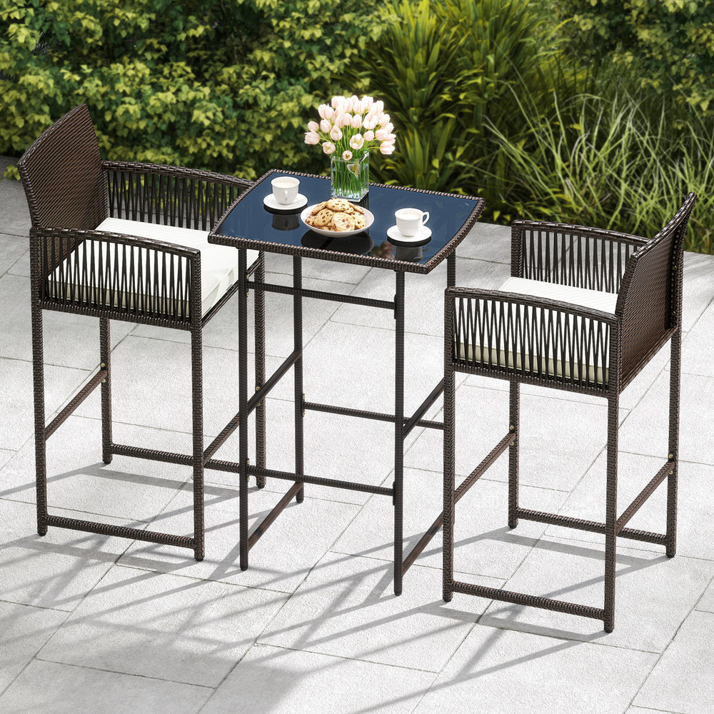3 piece patio bar set featuring a wicker table and two ergonomic armchairs with white cushions for outdoor relaxation.