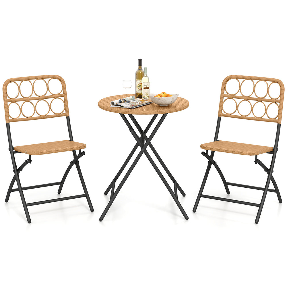 Folding round table and two chairs with handwoven rattan seats, perfect for outdoor patio or poolside relaxation.