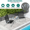 Two black folding chairs with a tempered glass coffee table, perfect for outdoor relaxation in a patio setting.
