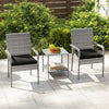 Two ergonomic patio chairs with black cushions and a tempered glass side table, perfect for balcony relaxation.