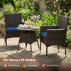 Two chairs and a round table in mix brown PE rattan, perfect for outdoor patio relaxation with navy cushions.