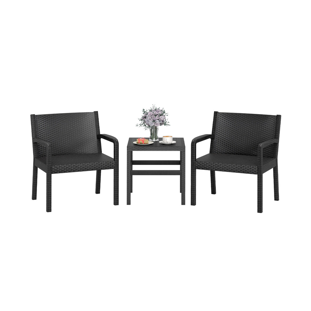 Two black rattan armchairs and a square side table, perfect for outdoor patio use and stylish relaxation.