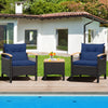 Two navy cushioned chairs with a brown rattan finish and acacia wood table, perfect for outdoor patio relaxation.