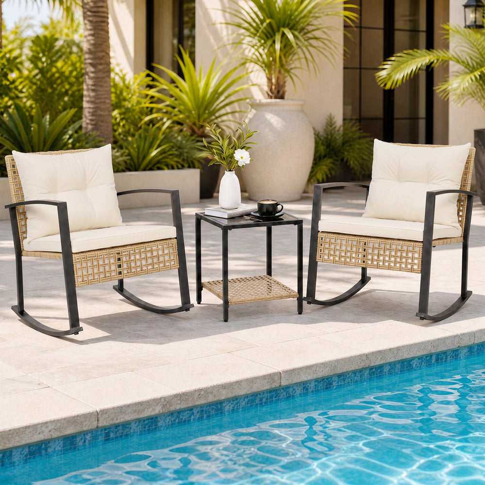 Glass-top coffee table with rattan storage basket complements two rocking chairs, creating an inviting outdoor conversation space.