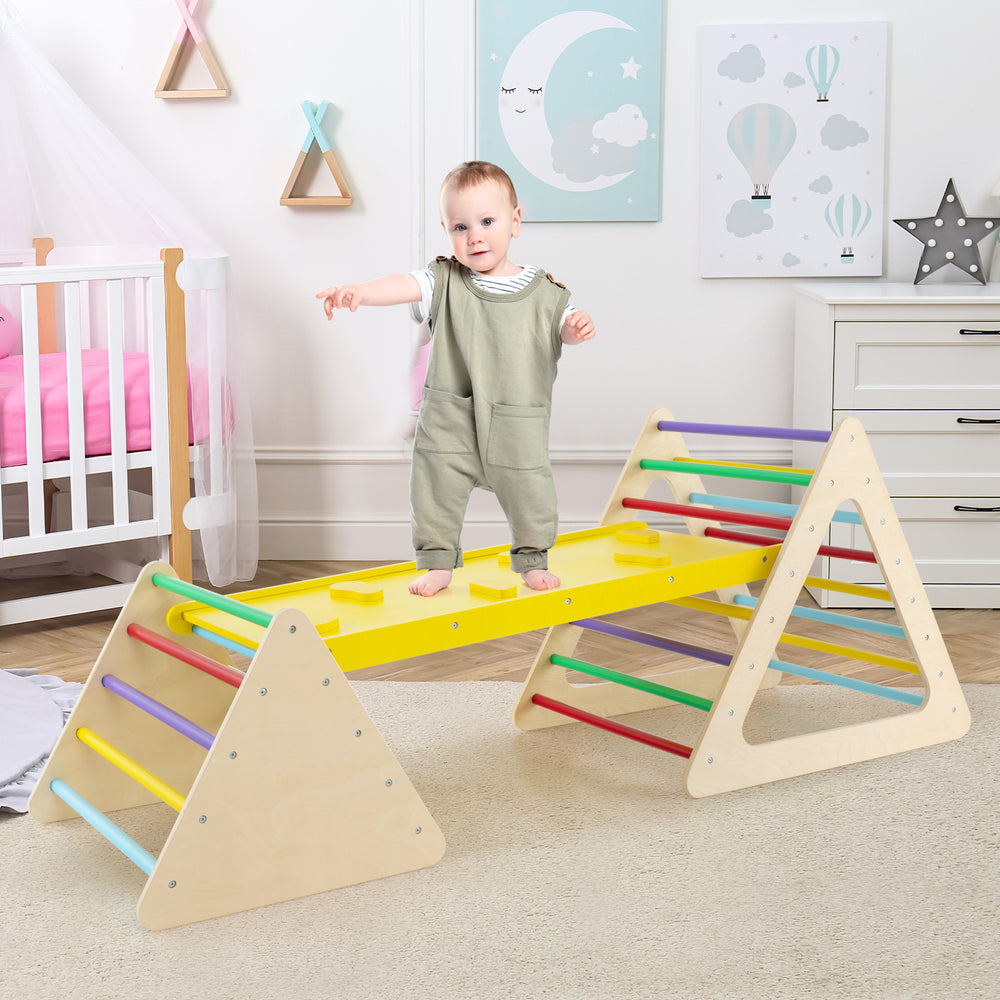 Toddler playing on the colorful Montessori climbing ramp and triangle set, promoting active play and physical skills.
