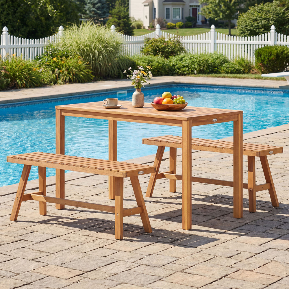 Acacia wood patio dining set with rectangular table and slatted benches, perfect for outdoor gatherings by the pool.