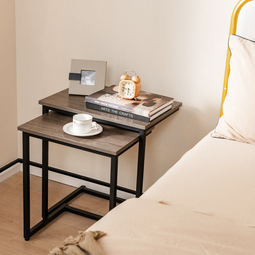Stackable C-shaped coffee end tables in oak finish, featuring a smooth surface and sturdy steel tube structure for.