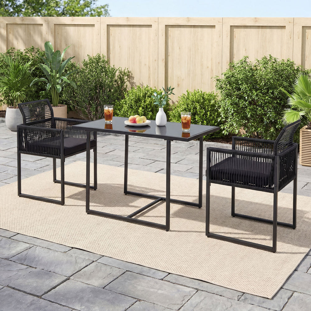 Outdoor dining set featuring a black metal frame, hand-woven PE rattan chairs, and a spacious tempered glass table for.