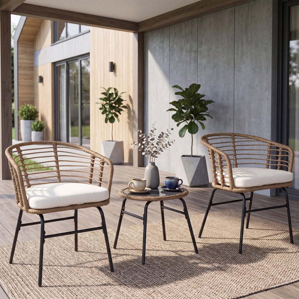 Two hand-woven PE rattan chairs with soft cushions and a round bistro table, perfect for outdoor patio relaxation.