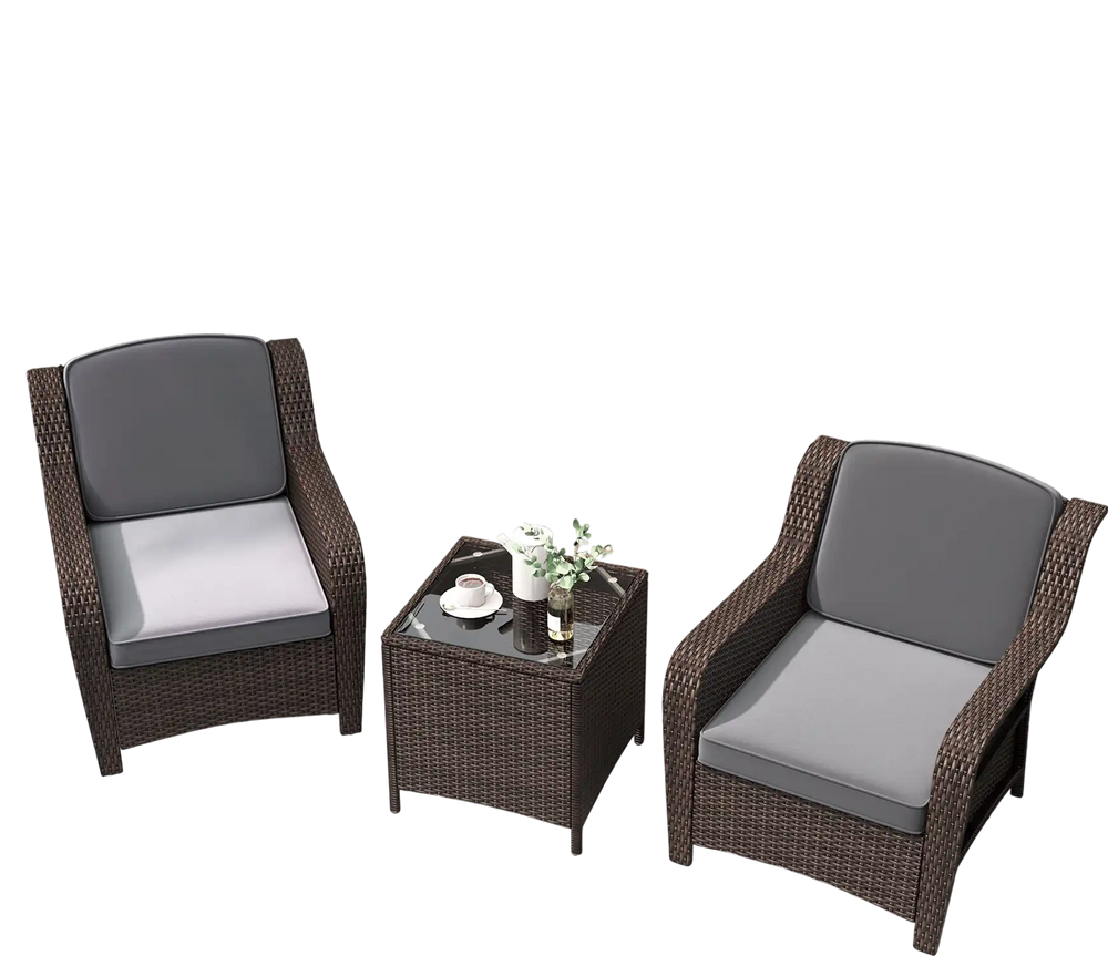 Two gray cushioned rattan chairs with a tempered glass coffee table, perfect for outdoor lounging on a patio.