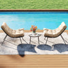 Cushioned papasan chairs in beige with a side table, perfect for outdoor lounging by the pool.