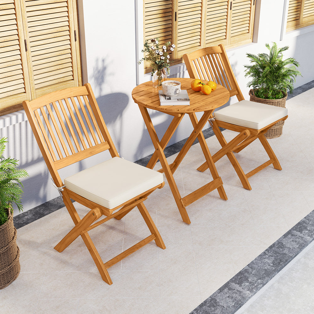 Acacia wood patio bistro set with beige cushions, featuring a folding design for easy storage and outdoor use.