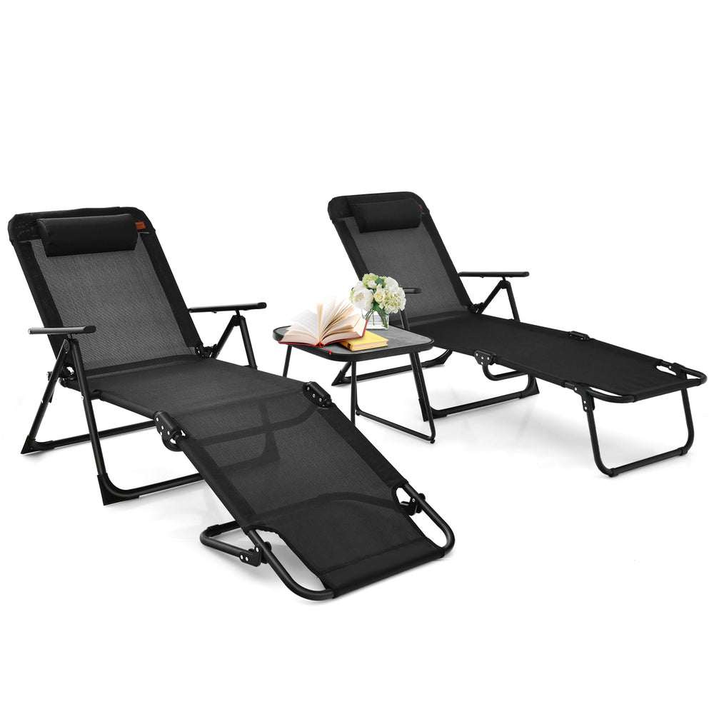 Two black folding patio chaise lounges with a faux marble accent table, perfect for outdoor relaxation and sunbathing.
