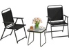 Two black folding patio chairs with a side table, perfect for outdoor relaxation in a garden or on a porch.