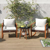 Two acacia wood armchairs with off-white cushions and a tempered glass top table, perfect for outdoor relaxation.
