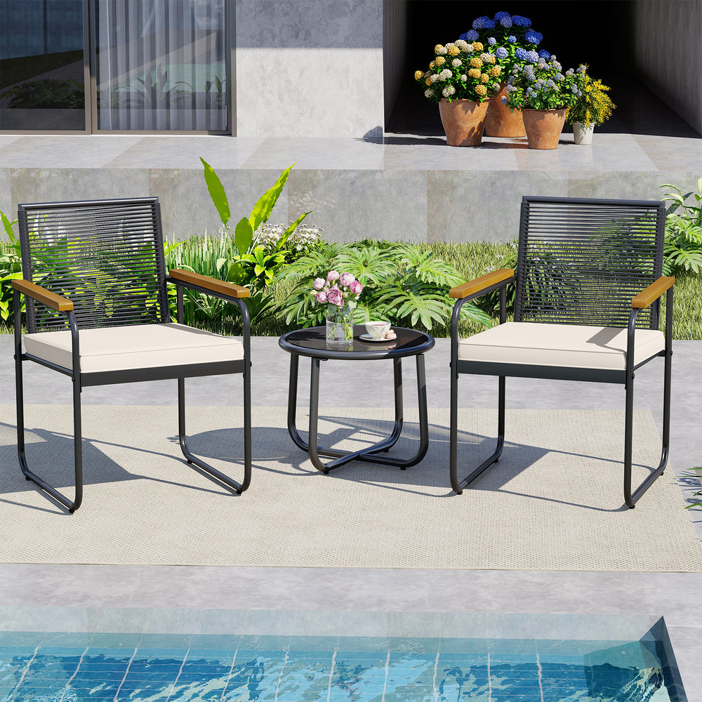 Two PE rattan patio chairs with white cushions and a round tempered glass table, perfect for poolside relaxation.
