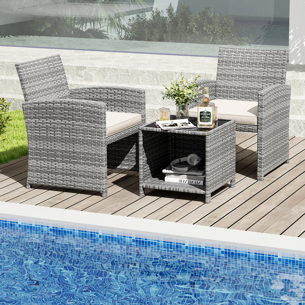 Two chairs and a coffee table in gray PE rattan with soft cushions, perfect for poolside relaxation.