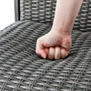 Close-up of the hand pressing the 4D air fiber cushion of a gray PE rattan swivel bar chair, showcasing comfort and.